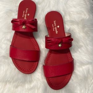 Brand: kate spade new york
Red leather slide sandal. 1/2" flat stacked heel.